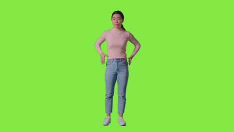 Full-Length-Studio-Portrait-Of-Frustrated-Or-Angry-Woman-Standing-Against-Green-Screen-1